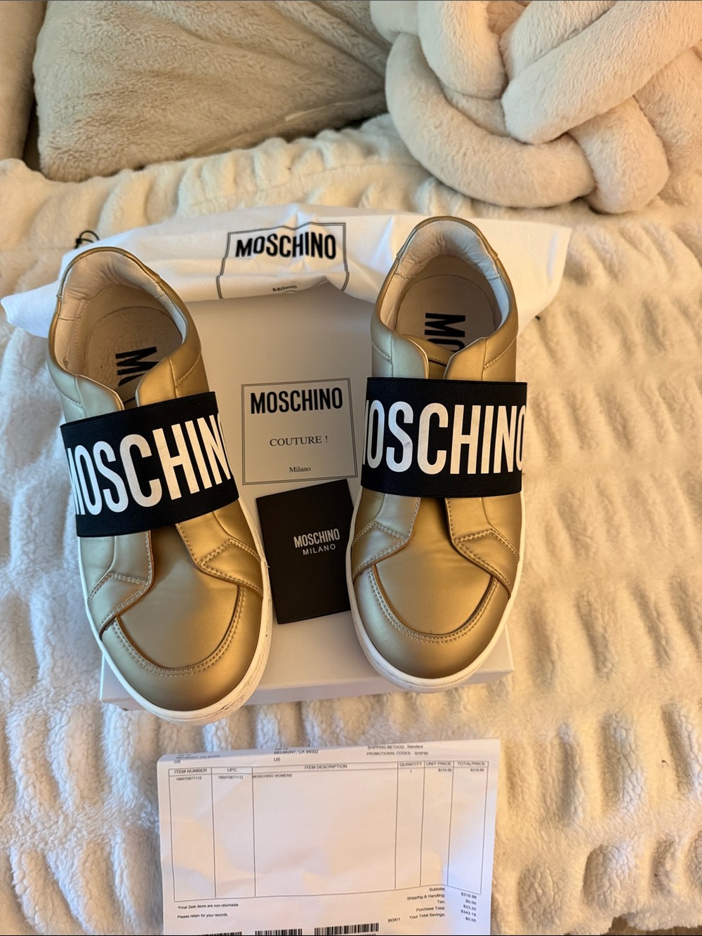 Moschino woman’s Metallic Gold Slip-On Sneakers with Bold Black Logo Strap